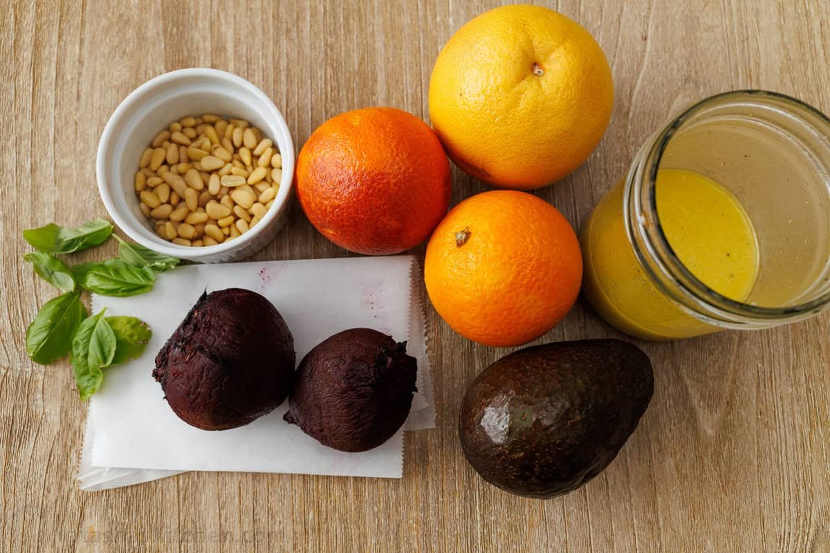 Citrus Salad looks so beautiful with fresh, colorful fruit and tastes amazing drizzled with sweetened lemon vinaigrette! Holiday-worthy dish. Ingredients for fruit side dish including grapefruit, oranges, avocado, pine nuts, beets and lemon vinaigrette