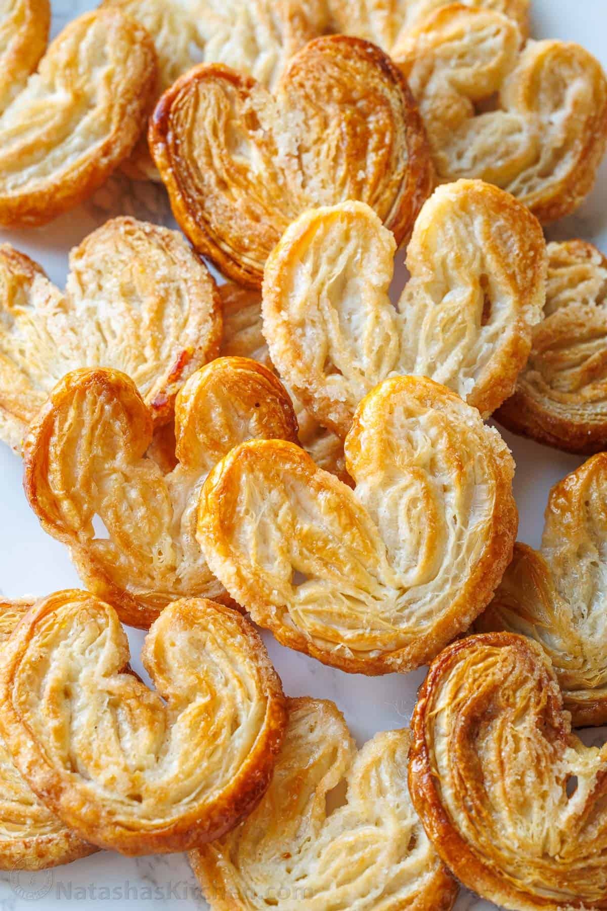 Palmiers pastries piled on a white plate