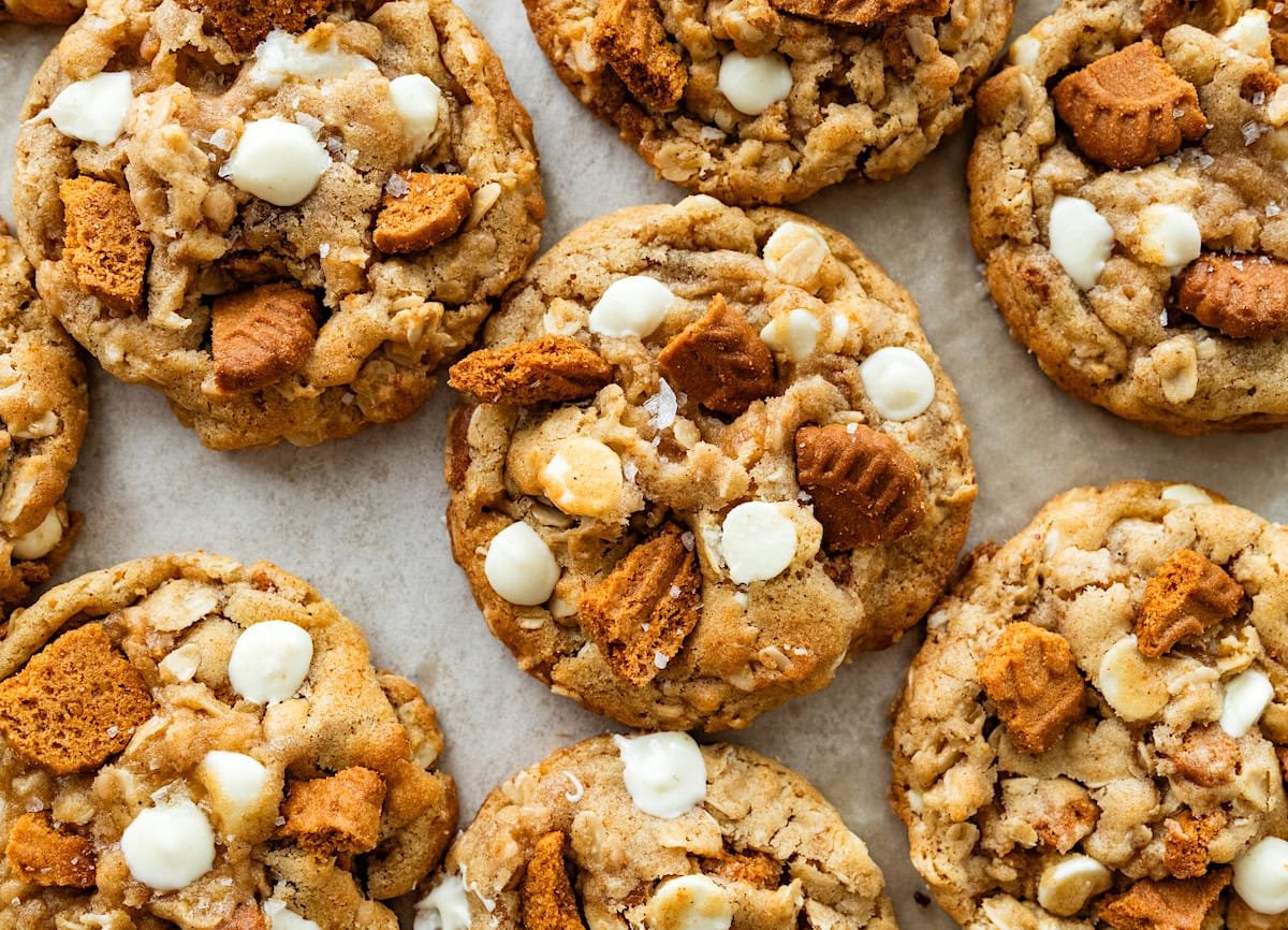 close up of Brown Butter Oatmeal Biscoff Cookies with Toffee & White Chocolate on baking sheet. 