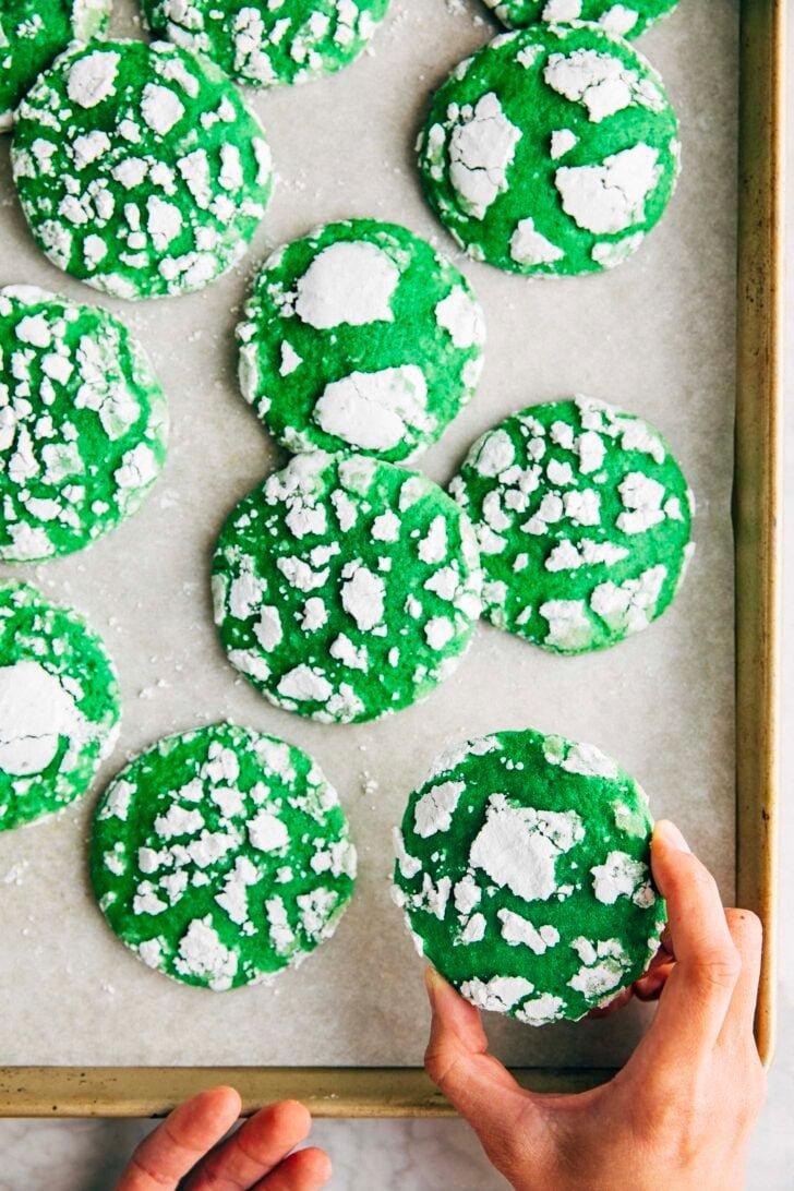 Photo of Michelle from Hummingbird High grabbing a pandan crinkle cookie from the sheet pan