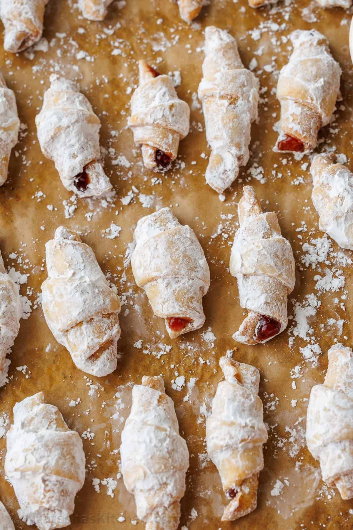 confectioners sugar sifted over rugelach cookies on butcher paper