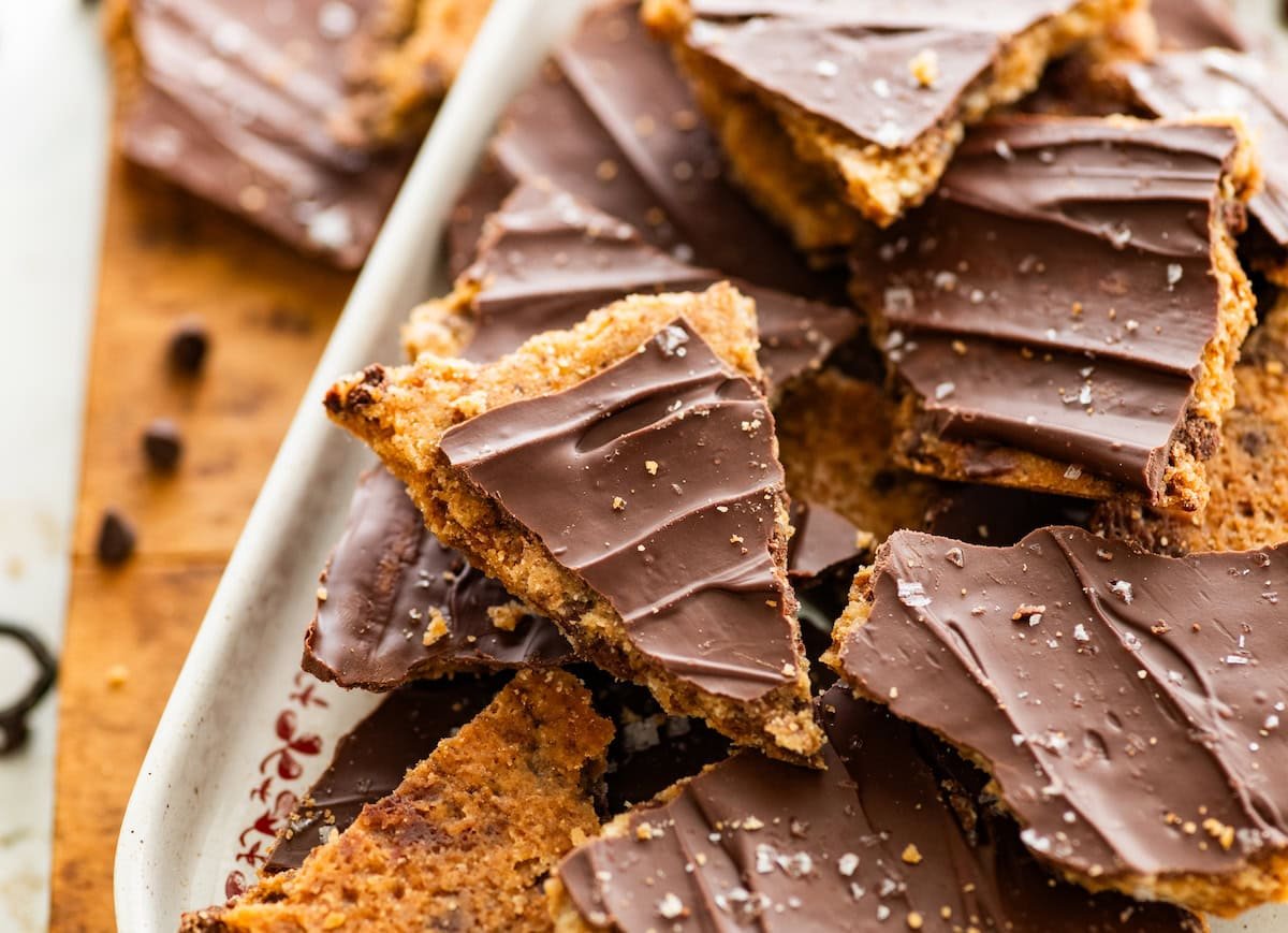 close up of chocolate chip cookie bar with layer of chocolate and flaky sea salt. 
