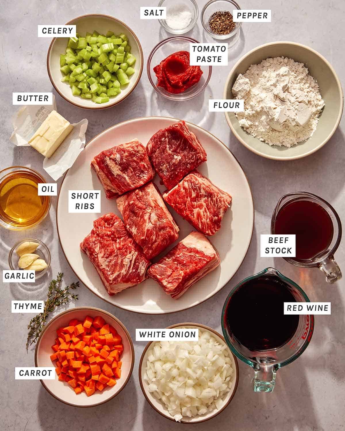 Ingredients to make the best braised short ribs all laid out on a kitchen counter.
