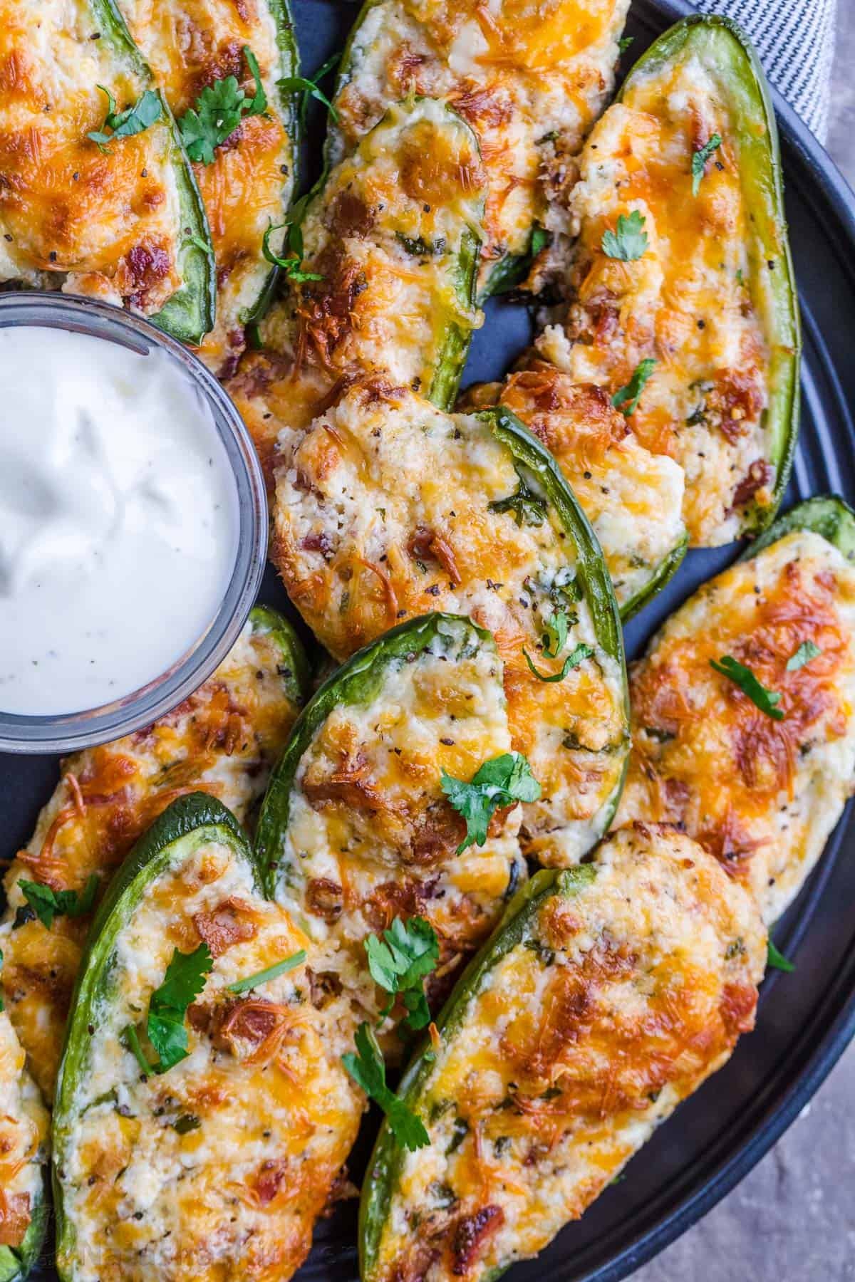 Jalapeno poppers arranged on tray with ranch