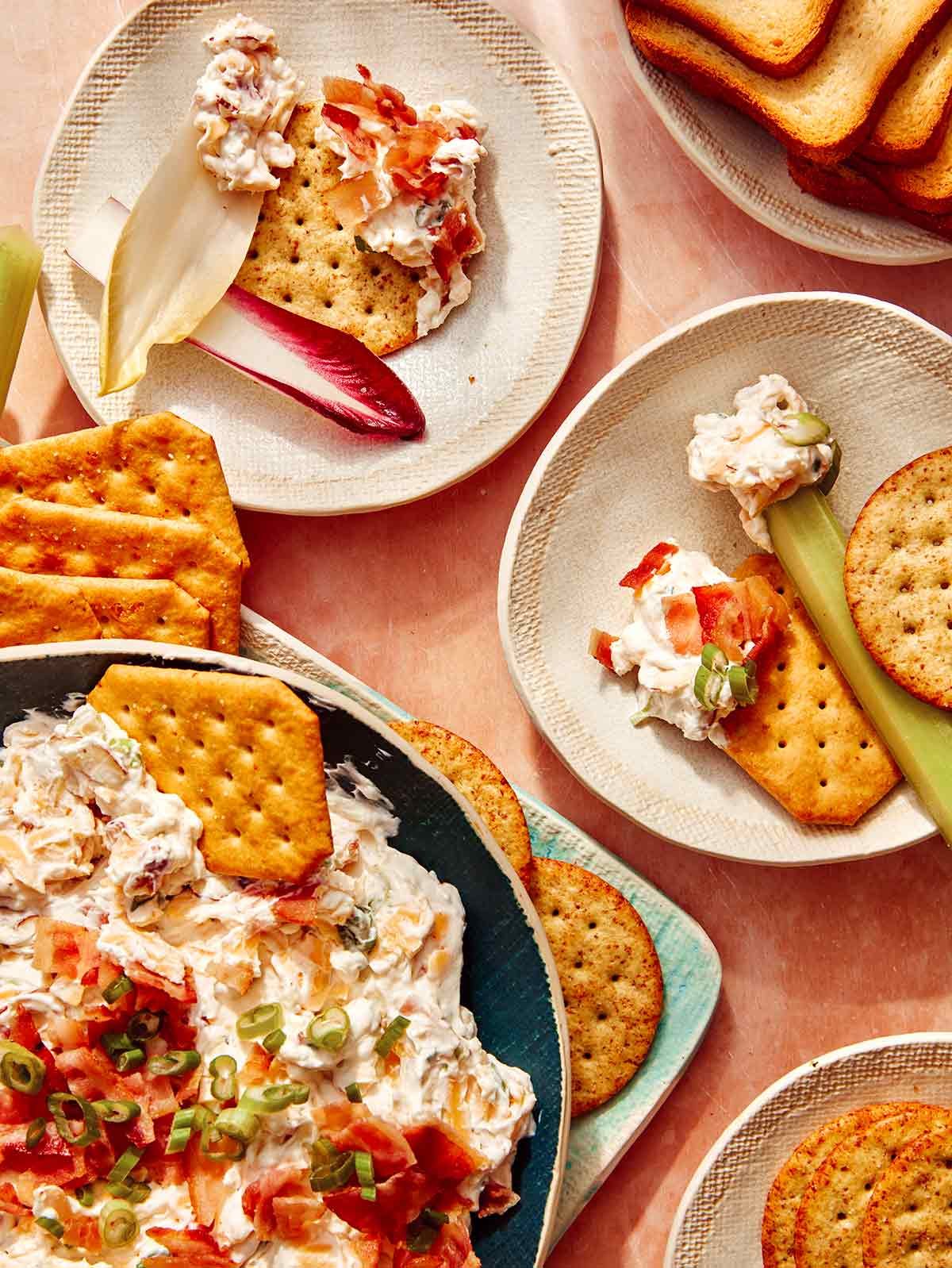 Million dollar dip being served onto little appetizer plates.