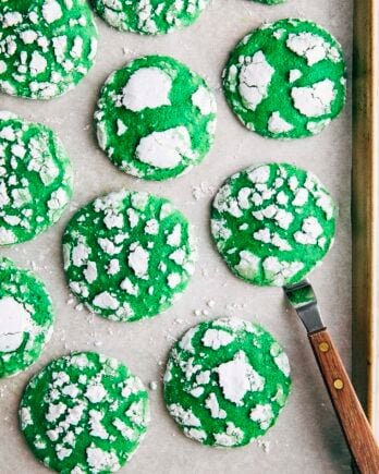 Photo of vibrant green pandan crinkle cookies on a gold sheet pan