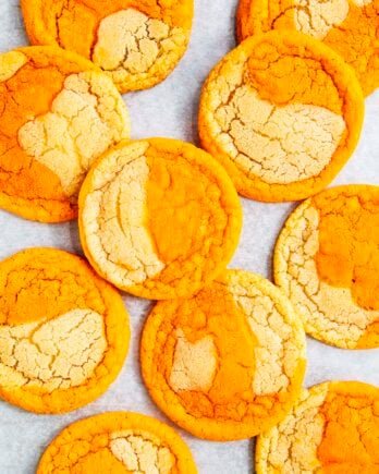 photo of thai tea cookies on a white parchment paper backdrop