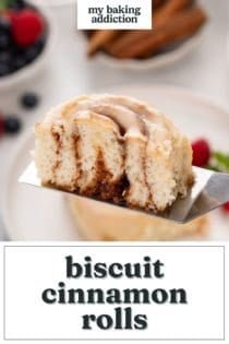Halved biscuit cinnamon roll being held up with a cake server to show the inside texture. Text overlay includes recipe name.