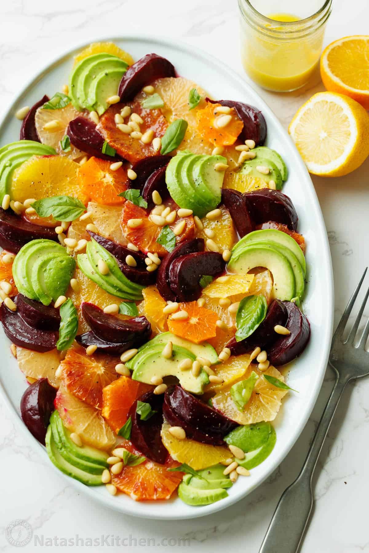 Citrus Salad is beautiful and delicious with fresh citrus, avocado, beets, basil, and pine nuts, drizzled with a bright lemon vinaigrette. Citrus salad on a platter with sliced avocado and pine nuts