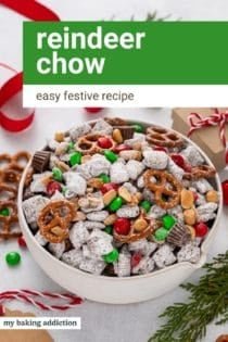 White bowl filled with reindeer chow surrounded by Christmas decorations. Text overlay includes recipe name.