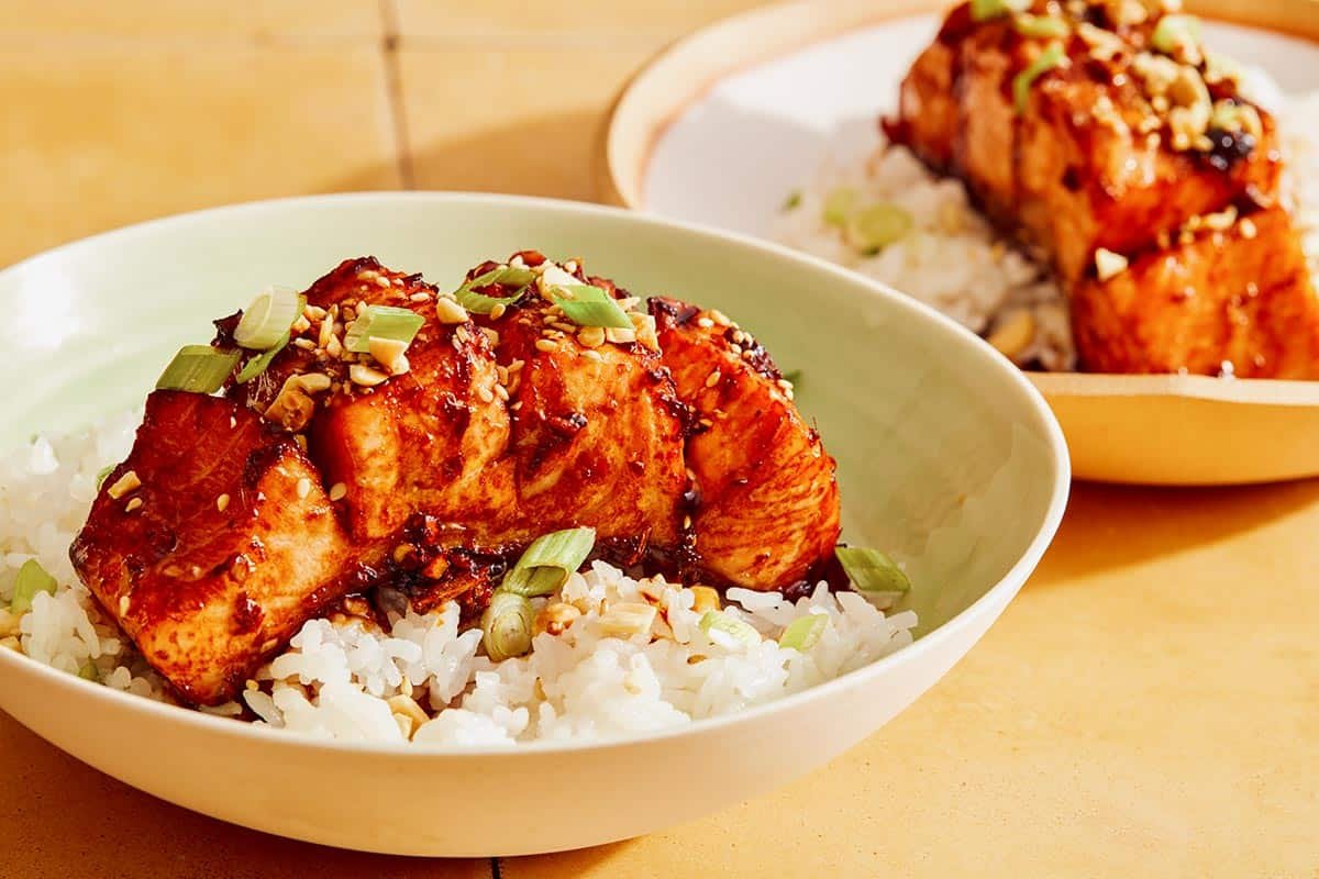 Hasselback salmon with a soy glaze recipe in two bowls with rice.