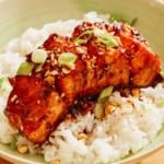 Hasselback salmon with a soy glaze recipe in two bowls with rice.