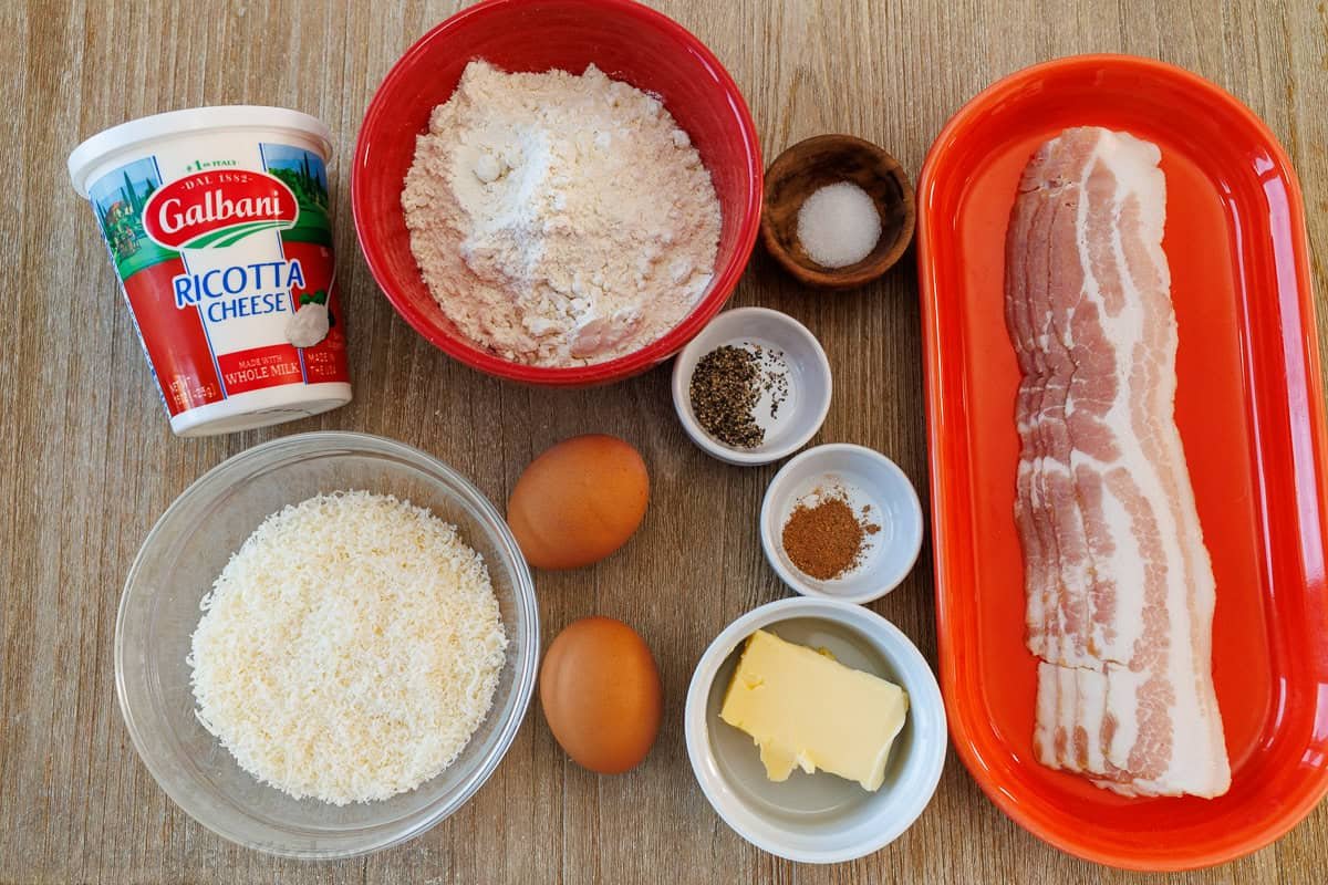 Easy Ricotta Gnocchi makes classic Italian dumplings sautéed in bacon butter for irresistible crispy edges. Make-ahead and Freezer-friendly! ingredients for homemade ricotta gnocchi including ricotta cheese, eggs, Parmesan cheese, salt, nutmeg, pepper, flour, bacon, and butter