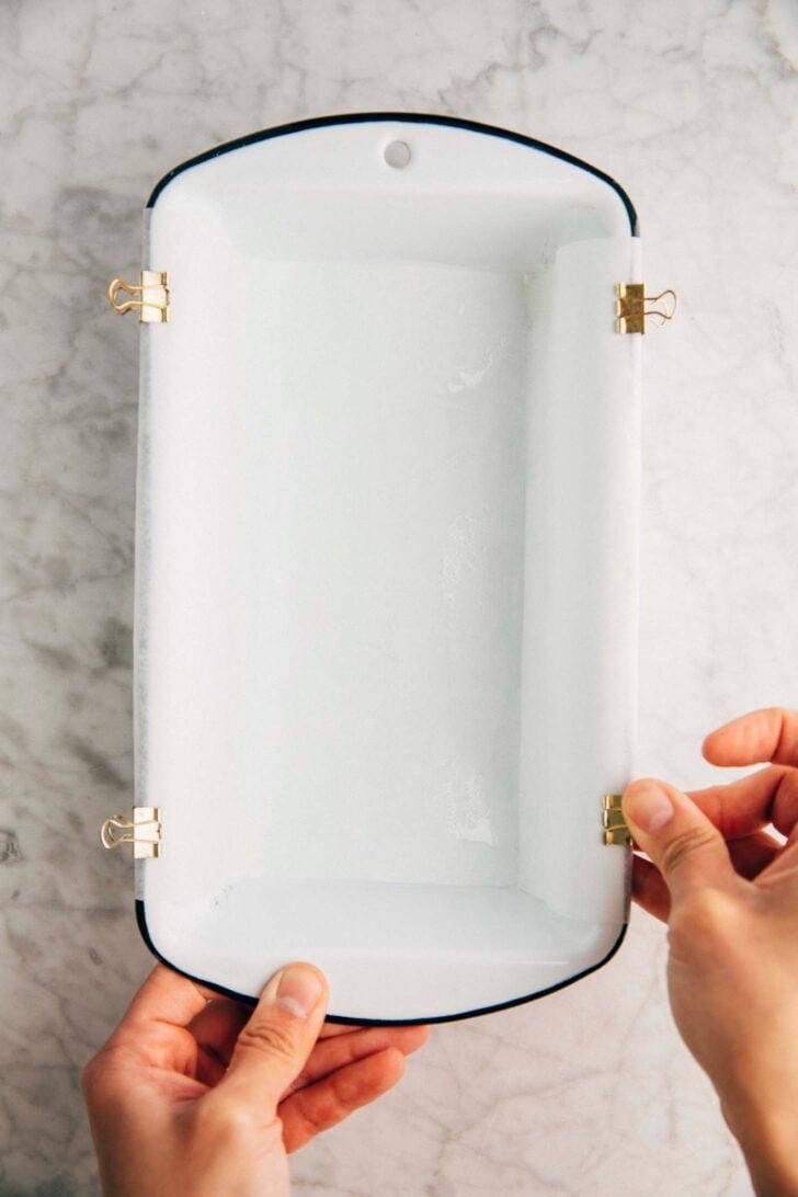 Photo of Michelle from Hummingbird High lining a loaf pan with parchment paper