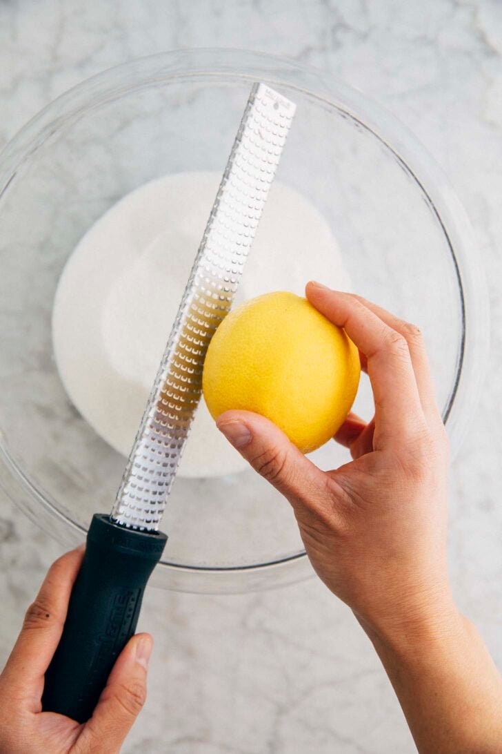 photo of Michelle from Hummingbird High zesting a lemon for the lemon yogurt loaf
