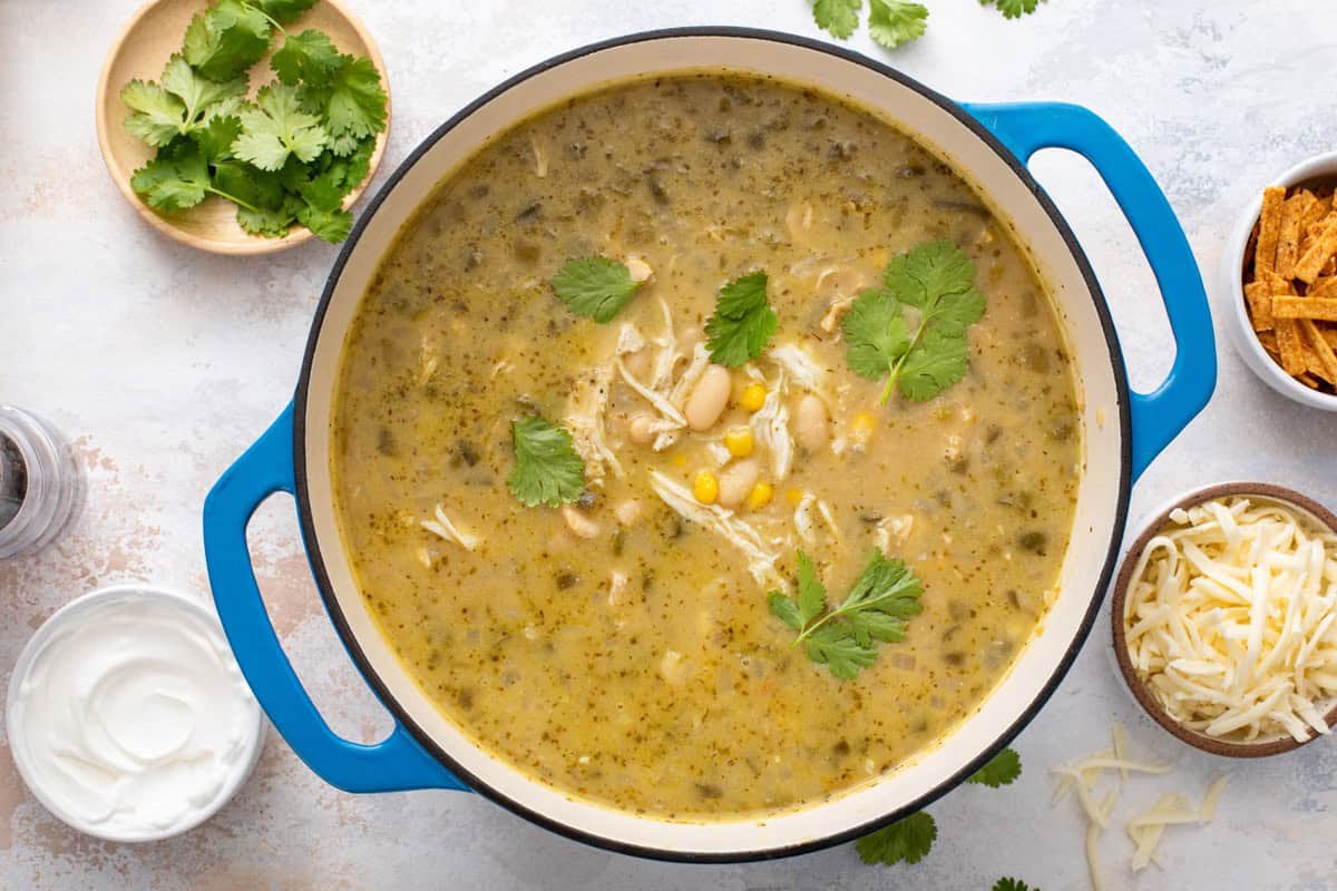 White chicken chili in a blue dutch oven on a countertop.