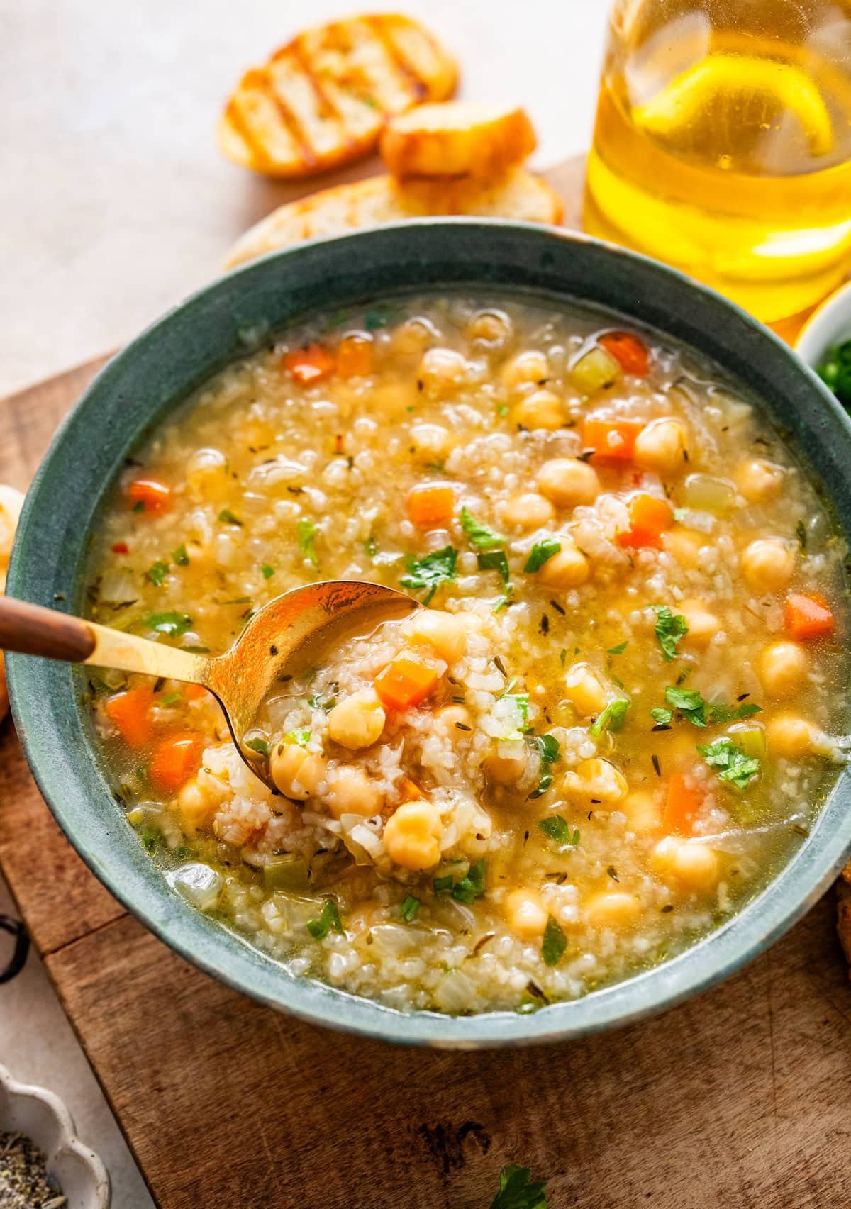 chickpea and rice soup in bowl with spoon.