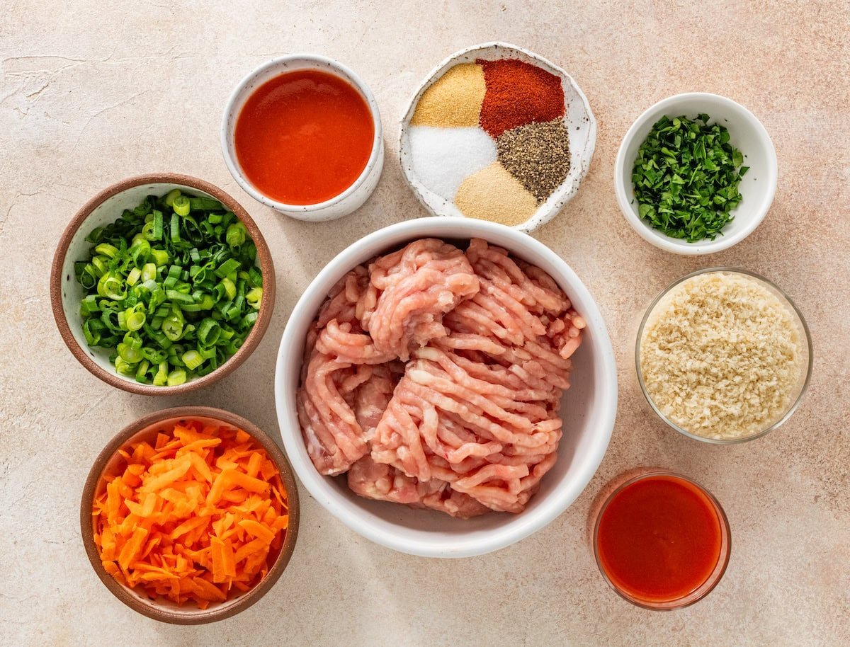 ingredients in bowls to make buffalo chicken meatballs.