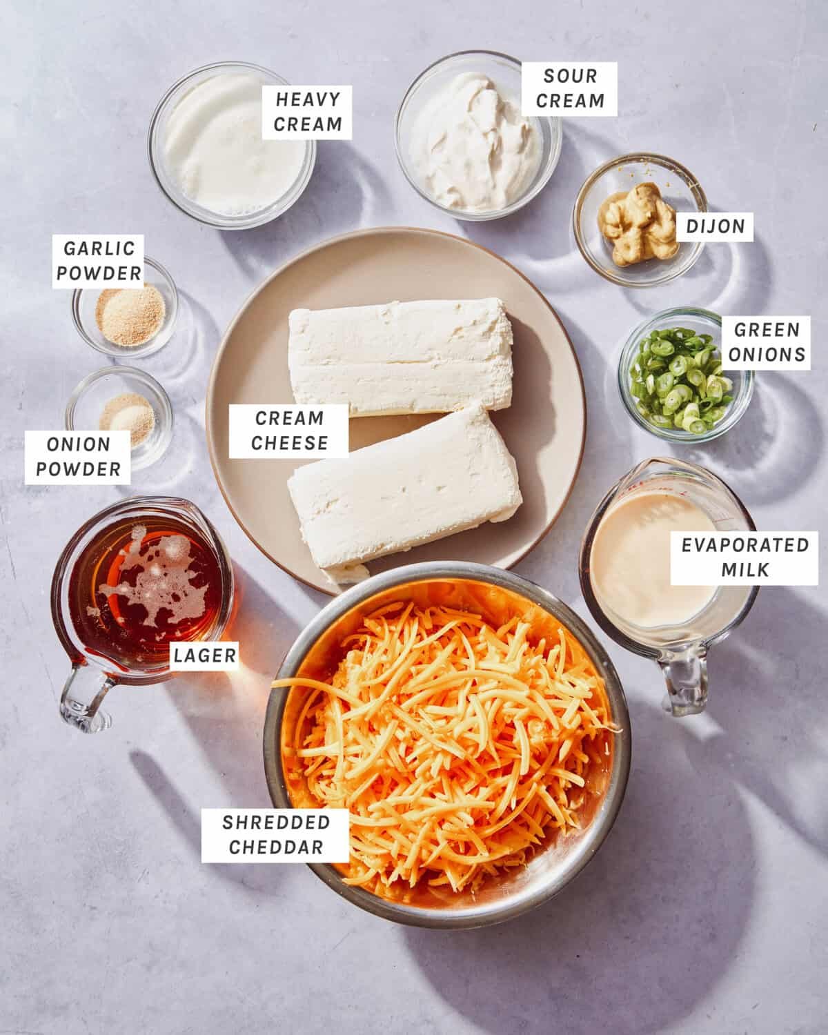 Crock pot beer cheese dip ingredients all laid out on a kitchen counter.