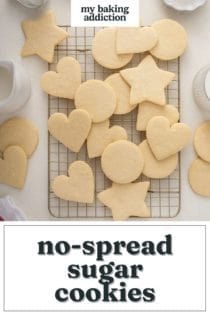 Undecorated no-spread sugar cookies in assorted shapes cooling on a wire rack on a countertop. Text overlay includes recipe name.
