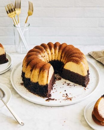 Photo of chocoflan bundt cake on a white plate.