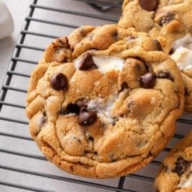 Close up of giant s'mores cookie on a wire rack.