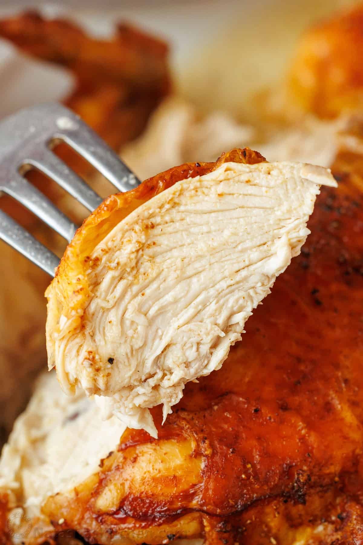 My Air Fryer Whole Chicken Recipe perfectly cooks a 3.5-5.5 pound bird with crispy skin and juicy meat. It's easy and perfectly seasoned. slice of meat from an air fryer whole chicken