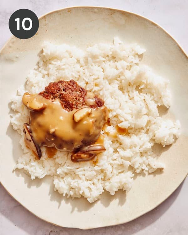 A hamburger patty with mushroom gravy on top.