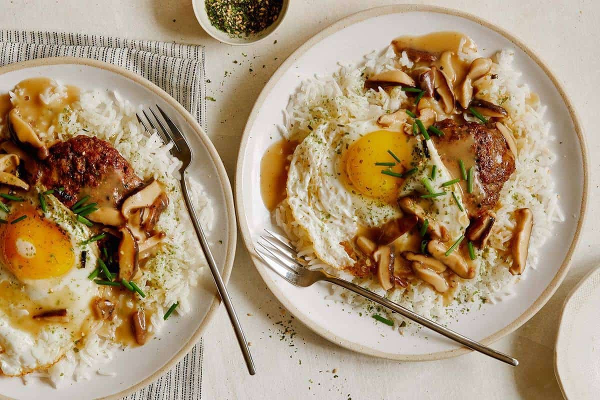 Loco moco served on two plates.