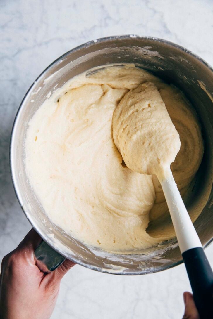 photo of condensed milk batter in a stand mixer bowl, showing batter texture