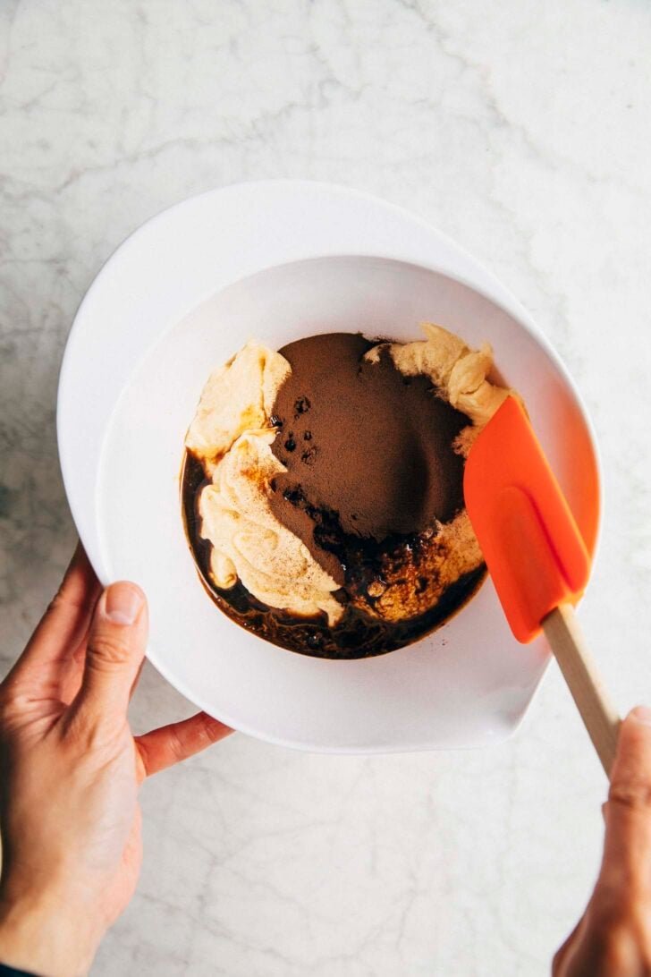 photo of Michelle adding espresso powder and coffee to the condensed milk batter to make coffee batter