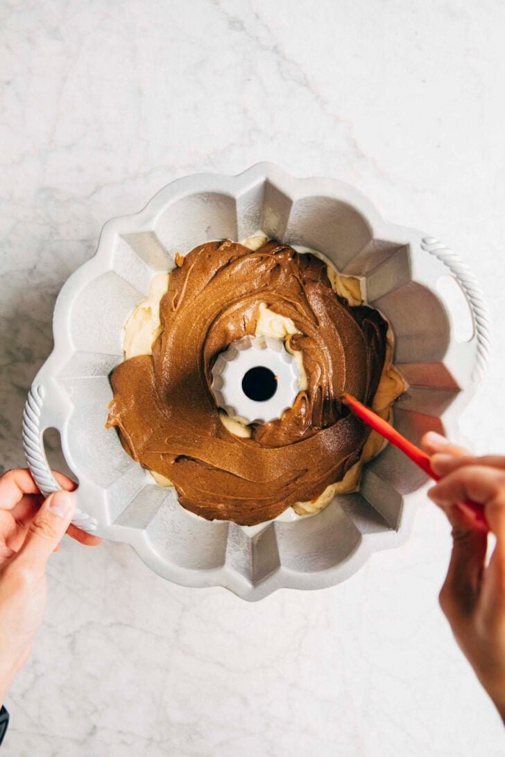 photo of michelle pouring the second layer of coffee batter for the bundt cake