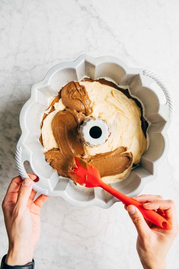 photo of michelle pouring the last layer of coffee batter for the vietnamese coffee bundt cake