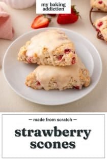 Two strawberry scones arranged on a white plate, with fresh berries in the background. Text overlay includes recipe name.