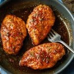 Honey glazed chicken breast recipe in a saute pan with a fork to serve