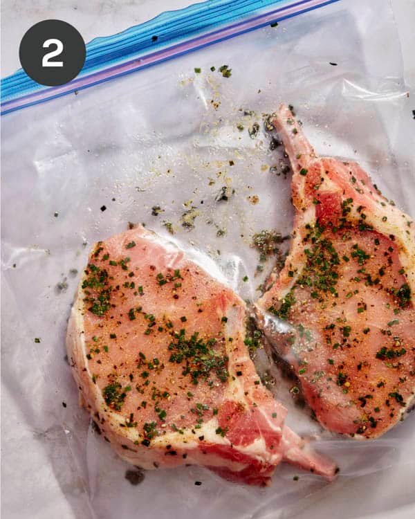 Pork chops marinating in a plastic bag.