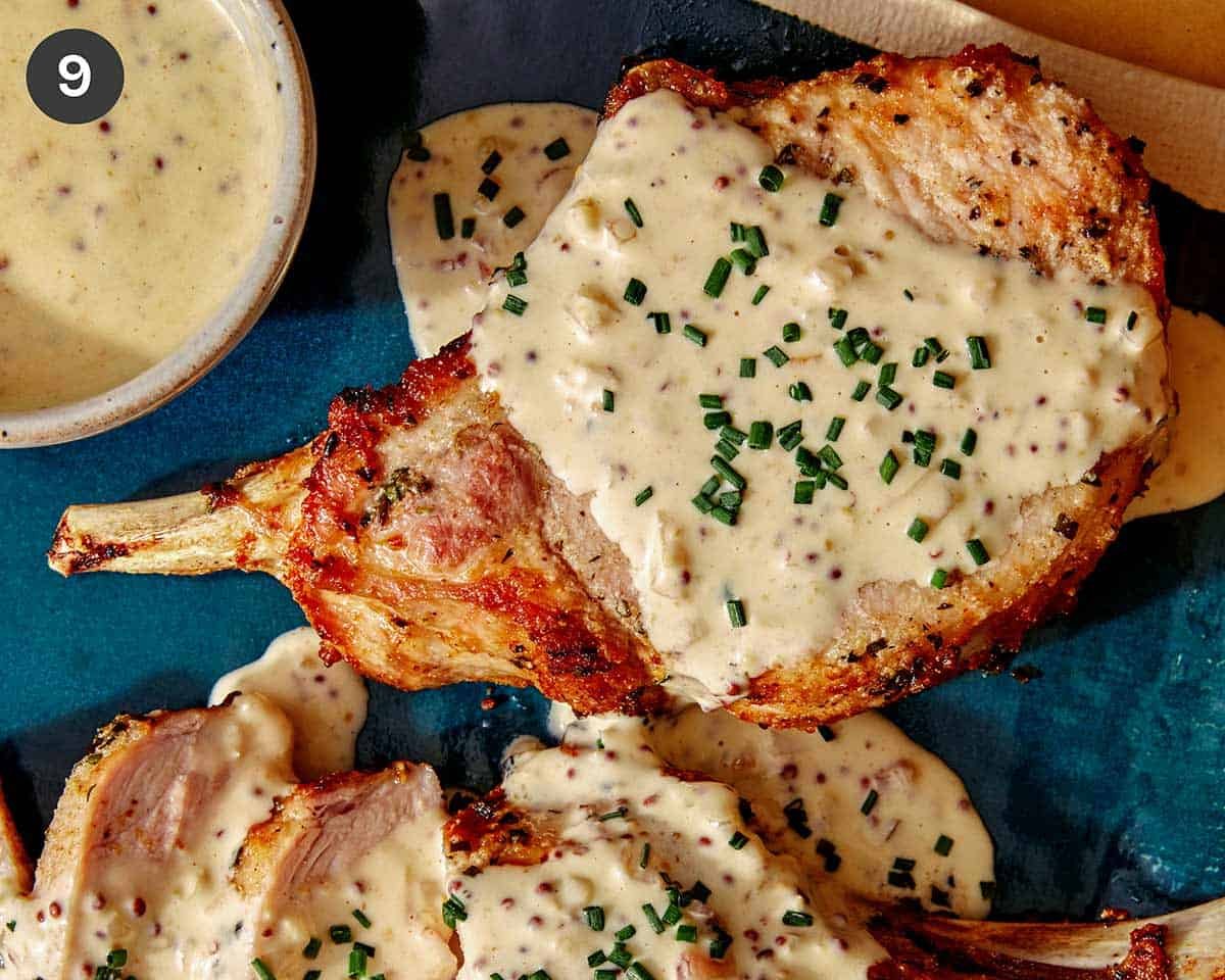 Air fryer pork chops on a plate covered in mustard sauce.