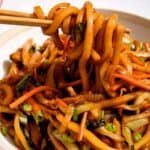 Yaki udon noodles in bowl being eaten.