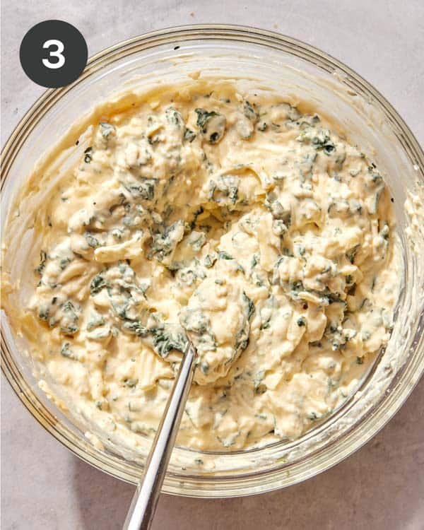 Mixed up cheese mixture in a bowl for lasagna roll ups in a bowl.