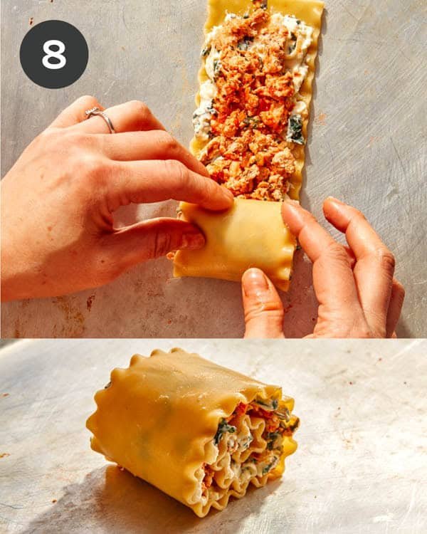 A lasagna sheet with meat and cheese being rolled up.