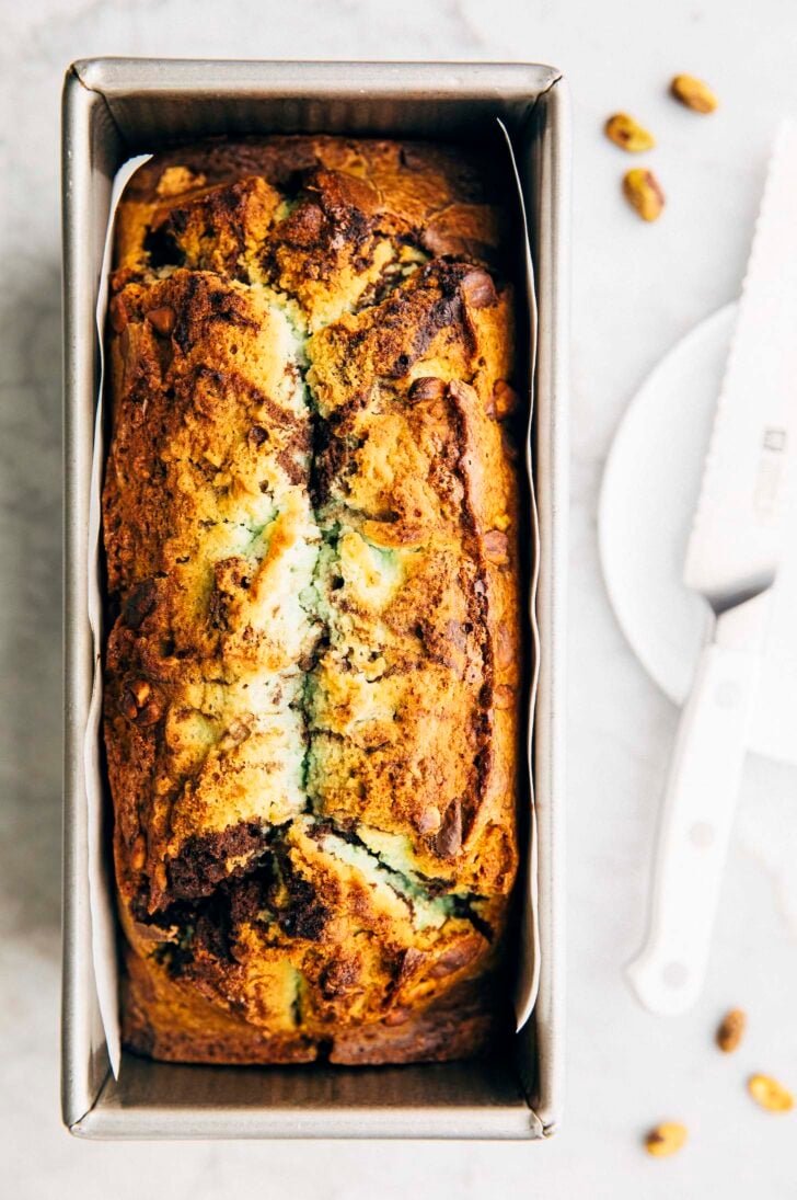 photo showing the chocolate pistachio loaf in a metal pan, unsliced