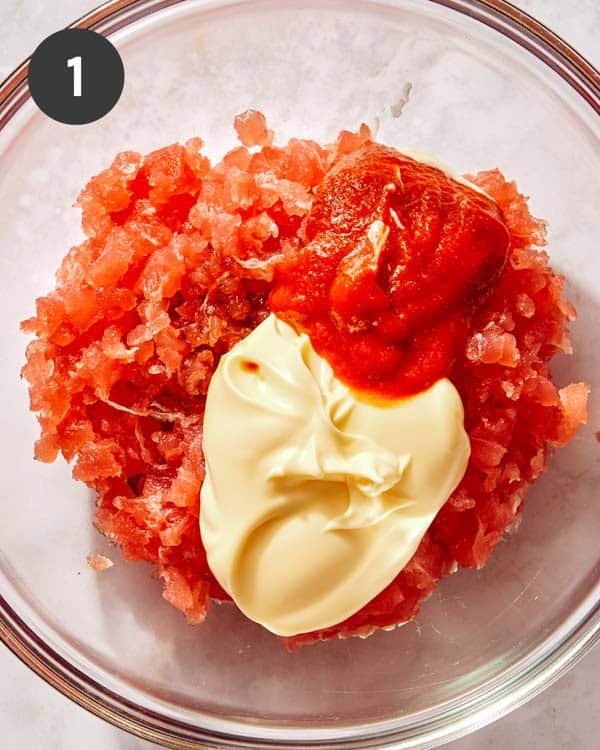 Tuna and sriracha, with kewpie in a bowl being mixed together.