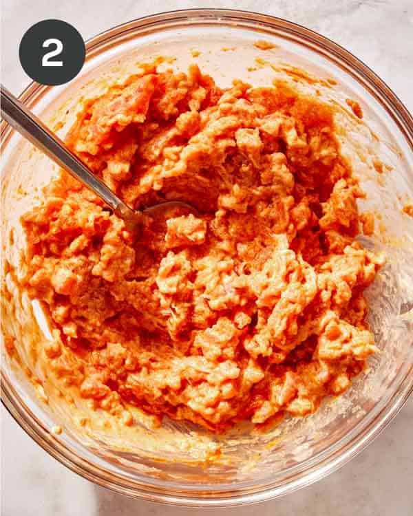 Spicy tuna in a bowl mixed together.
