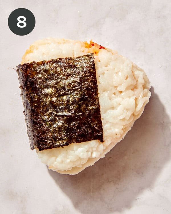 Tuna onigri with a piece of nori on the outside.