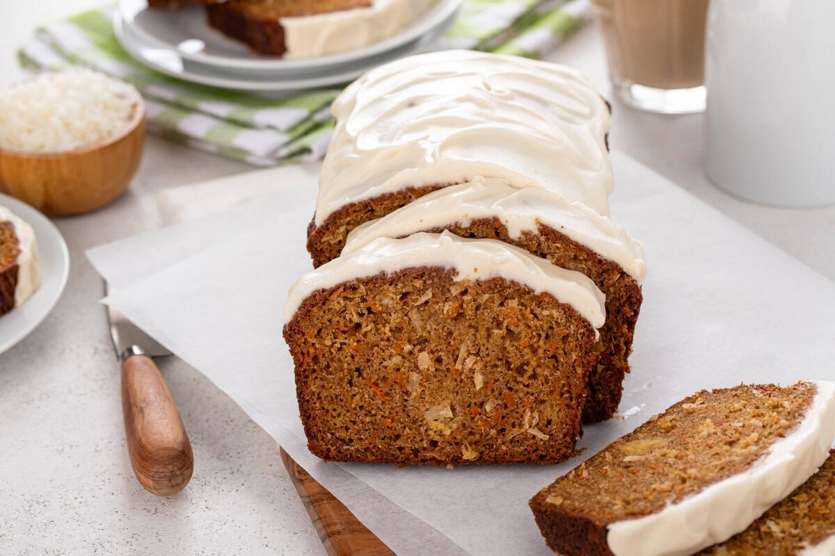 Front view of a sliced loaf of carrot cake bread to show the bread's texture.