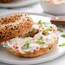 Veggie cream cheese spread on a bagel.