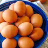 large plate of brown eggs on a blue plate