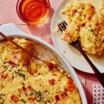 Corn casserole recipe with some scooped out on a plate.