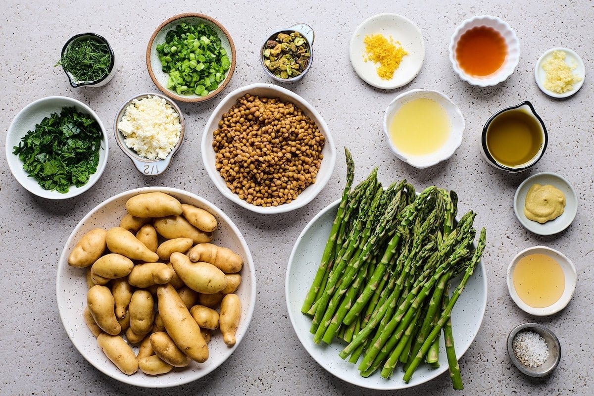 ingredients in bowls to make Potato Asparagus Lentil Salad with Lemon Dijon Dressing. 