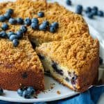blueberry coffee cake with crumb topping and fresh blueberries on top